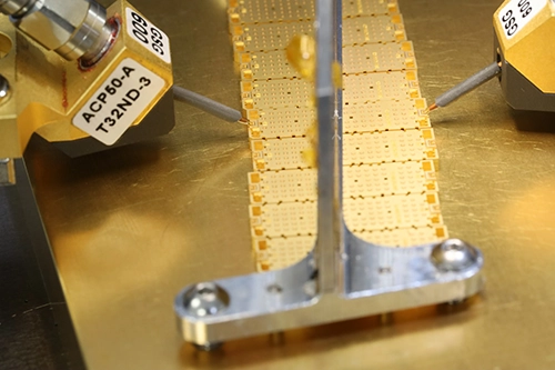 Off-wafer probe setup showing the singulated PolyStrata filter under RF probes
